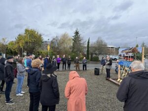 Community leaders and members standing at the Parthia Groundbreaking event. 