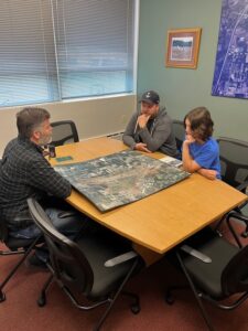 Olympia Regional Airport (OLM) Senior Manager, Chris Paolini, shares a map of OLM with Arik and father, Jesse.