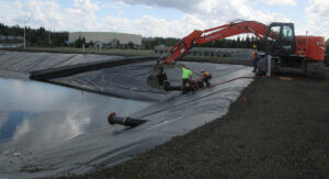Port of Olympia staff with heavy equipment at marine terminal to maintain the stormwater treatment system.