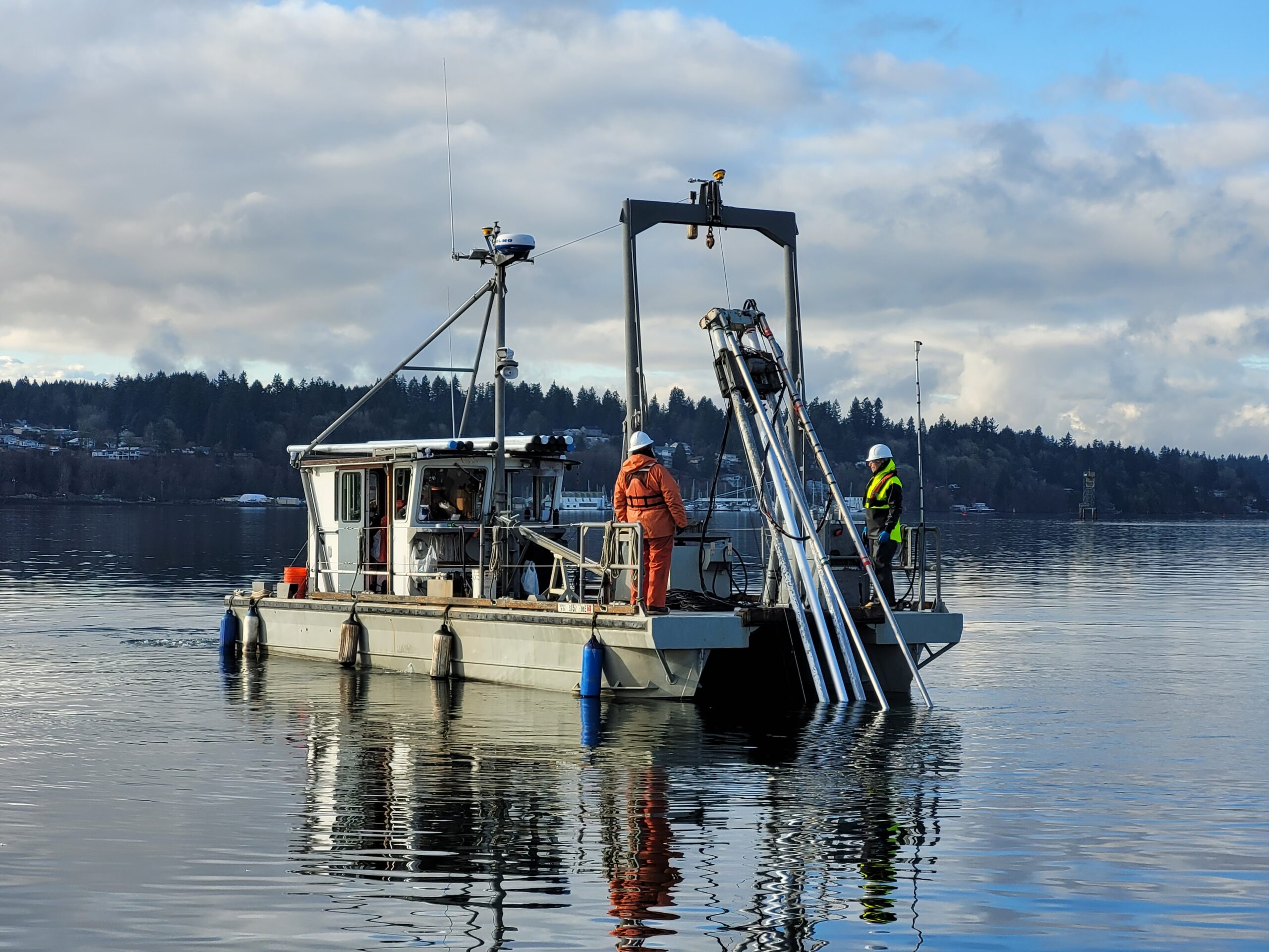 A research vessel collects sediment samples from East Bay of Budd Inlet.